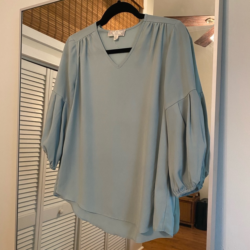 Sheer mint blue blouse with cinched bell sleeves